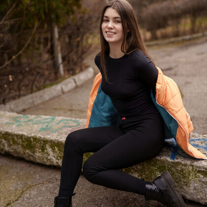 Danna 001 01-danna-bliss-outdoor-tease-in-black-outfit-and-orange-jacket-scene.jpg