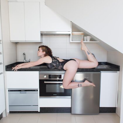 Sathira 001 02-tattooed-beauty-strips-in-kitchen-with-black-lace-tease.jpg